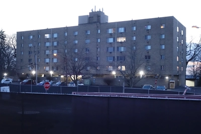 A high-occupancy 6-floor apartment sits at the bottom of the ramp next to other apartments.